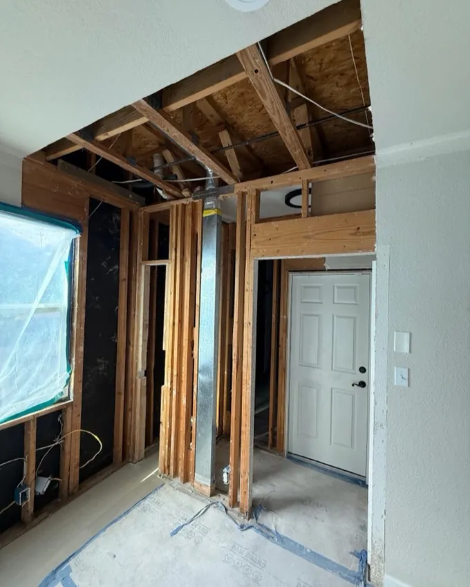Home interior stripped to the studs during water damage demolition and structural drying in Austin
